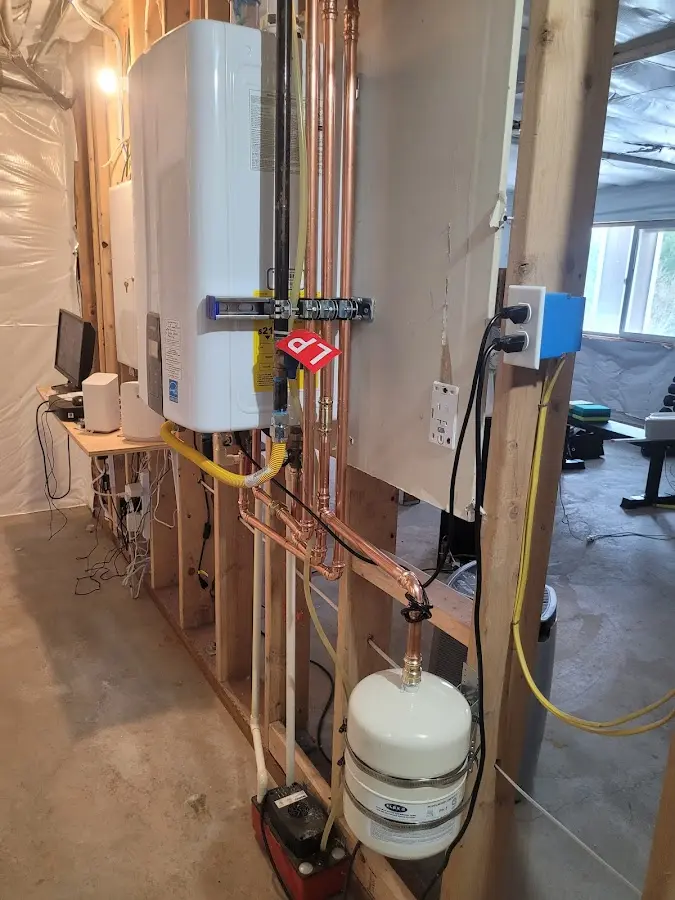 Licensed plumber repairing a kitchen sink in Somers